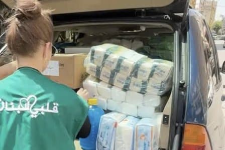 A volunteer in the charity’s green vest